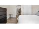 Spacious bedroom with hardwood floors, dark dresser, and neutral decor at 9390 W Chatfield Pl # 108, Littleton, CO 80128