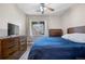 Cozy bedroom with hardwood floors, TV, and a view of the outdoor scenery at 9390 W Chatfield Pl # 108, Littleton, CO 80128