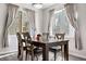 Elegant dining room with a wooden table, upholstered chairs, and natural light at 9390 W Chatfield Pl # 108, Littleton, CO 80128