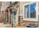 Charming condo entrance featuring stone accents, neutral siding, and a well-maintained walkway at 9390 W Chatfield Pl # 108, Littleton, CO 80128