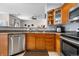 Renovated kitchen with stainless steel dishwasher, natural wood cabinets, and bar seating at 9390 W Chatfield Pl # 108, Littleton, CO 80128