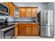 Charming kitchen with stainless steel appliances, ample cabinet space, and stylish tile flooring at 9390 W Chatfield Pl # 108, Littleton, CO 80128