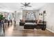 Bright living room featuring hardwood floors, a comfortable sectional sofa, and natural light at 9390 W Chatfield Pl # 108, Littleton, CO 80128