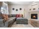 Cozy living room with a fireplace, plush sectional sofa, and stylish decor at 9390 W Chatfield Pl # 108, Littleton, CO 80128