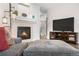 Inviting living room showcasing a fireplace, TV, and access to a bathroom at 9390 W Chatfield Pl # 108, Littleton, CO 80128