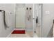 Clean, bright bathroom with tile floor, glass-enclosed shower, and neutral colored towels at 9390 W Chatfield Pl # 108, Littleton, CO 80128