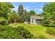 Backyard featuring lawn, trees, a small back deck, and lush landscaping for privacy at 8940 W 80Th Dr, Arvada, CO 80005