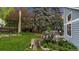 Lush backyard featuring a wooden deck, mature trees, and a well-maintained lawn at 8940 W 80Th Dr, Arvada, CO 80005