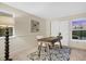 Bright bedroom featuring a wooden desk, neutral carpet, and a large window providing natural light at 8940 W 80Th Dr, Arvada, CO 80005