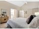 Bright bedroom with en-suite bathroom, vaulted ceiling, and dual closets at 8940 W 80Th Dr, Arvada, CO 80005
