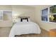 Bright bedroom with big windows, carpeted floor and table lamp at 8940 W 80Th Dr, Arvada, CO 80005
