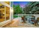 Outdoor wooden deck with a dining table and chair set perfect for entertaining or relaxing at 8940 W 80Th Dr, Arvada, CO 80005