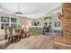 Elegant dining area with a glass table, modern lighting, and a view to the open living area at 8940 W 80Th Dr, Arvada, CO 80005