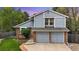 Charming two-story home with brick accents, an attached two-car garage, and a well-manicured lawn at 8940 W 80Th Dr, Arvada, CO 80005