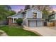 Charming two-story home with blue siding, brick accents, and a well-manicured lawn at 8940 W 80Th Dr, Arvada, CO 80005