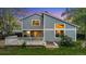 Two-story home with a spacious deck, well-manicured lawn, and lush landscaping at 8940 W 80Th Dr, Arvada, CO 80005