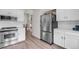 Bright kitchen with stainless steel refrigerator and appliances with subway tile backsplash at 8940 W 80Th Dr, Arvada, CO 80005