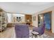 Open living area with a brick fireplace, comfortable chairs, and easy access to the dining room at 8940 W 80Th Dr, Arvada, CO 80005