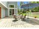 Back patio with a seating area, shade umbrella, and well-maintained yard at 8940 W 80Th Dr, Arvada, CO 80005