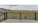 Scenic back deck with black metal railing overlooking open space and white fencing at 5775 Pinto Valley St, Parker, CO 80134