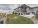 Landscaped backyard with patio, steps and black metal railing overlooking lawn at 5775 Pinto Valley St, Parker, CO 80134