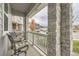 Inviting front porch featuring stone columns, comfortable seating, and a view of the neighborhood at 5775 Pinto Valley St, Parker, CO 80134