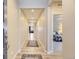 Inviting hallway with recessed lighting, wood floors, and open doorway to bedroom at 5775 Pinto Valley St, Parker, CO 80134