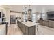 Modern kitchen featuring a large island, stainless steel appliances, and open to the living room at 5775 Pinto Valley St, Parker, CO 80134