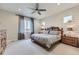 Spacious main bedroom with carpet, fan, plenty of natural light and a decorative, wooden headboard at 5775 Pinto Valley St, Parker, CO 80134