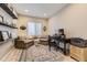 Well-lit home office with shelving, neutral colors, and comfortable seating at 5775 Pinto Valley St, Parker, CO 80134