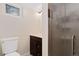 Bathroom featuring a vanity with dark wood cabinets, a shower with glass doors, and a toilet at 1434 Clermont St, Denver, CO 80220