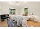 Cozy bedroom with hardwood floors, windows, and comfortable furnishings at 1434 Clermont St, Denver, CO 80220