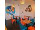 Charming dining area with colorful chairs, artistic mural, and stylish wooden accents creating a unique ambiance at 1434 Clermont St, Denver, CO 80220