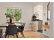 Charming dining room featuring a rustic table and modern decor adjacent to kitchen at 1434 Clermont St, Denver, CO 80220