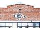 A classic brick building displaying the charming sign of The Owl Saloon, ready to offer drinks and a good time at 1434 Clermont St, Denver, CO 80220