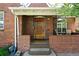 Inviting front porch with brick accents, a wooden door, and a welcoming entrance at 1434 Clermont St, Denver, CO 80220