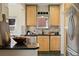 Charming kitchen boasts granite countertops, wooden cabinetry, and stainless steel appliances at 1434 Clermont St, Denver, CO 80220