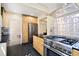 The kitchen features stainless steel appliances and light wood cabinets at 1434 Clermont St, Denver, CO 80220