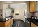 The modern kitchen features stainless appliances, black countertops, and tile backsplash at 1434 Clermont St, Denver, CO 80220