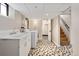 Well-lit laundry room with vintage-style flooring, laundry sink, and modern washer and dryer at 1434 Clermont St, Denver, CO 80220