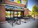 Outdoor patio seating area at mici restaurant featuring tables, chairs, and a fenced perimeter at 1434 Clermont St, Denver, CO 80220