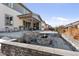 An inviting backyard featuring a stone fire pit, covered patio, and beautifully landscaped surroundings at 14593 Tango Loop, Parker, CO 80134