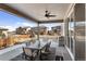 Covered patio with ceiling fan and outdoor dining, perfect for entertaining or relaxing with neighborhood views at 14593 Tango Loop, Parker, CO 80134