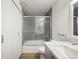 Bathroom features modern shower/tub combo with glass doors, double vanity, and contemporary finishes at 8225 Fairmount Dr # 10-204, Denver, CO 80247