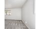 A bright bedroom with soft gray carpet and neutral walls, lit by a window at 8225 Fairmount Dr # 10-204, Denver, CO 80247