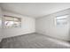 Bright bedroom featuring carpet floors, white walls, and windows offering natural light at 8225 Fairmount Dr # 10-204, Denver, CO 80247