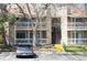 Exterior of the complex highlighting the stone chimney, stairs, and private balconies at 8225 Fairmount Dr # 10-204, Denver, CO 80247