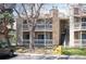 Two-story condo featuring balconies, stone accents, and stairs leading to upper units at 8225 Fairmount Dr # 10-204, Denver, CO 80247