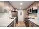 Modern kitchen featuring wood cabinets, stainless steel appliances, and white countertops at 8225 Fairmount Dr # 10-204, Denver, CO 80247