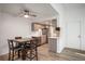 A well-lit kitchen and dining area, complete with stainless steel appliances and a modern ceiling fan at 8225 Fairmount Dr # 10-204, Denver, CO 80247